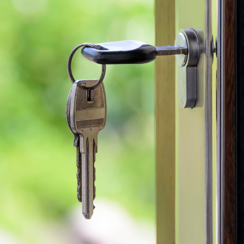 Keys hanging from a door lock.