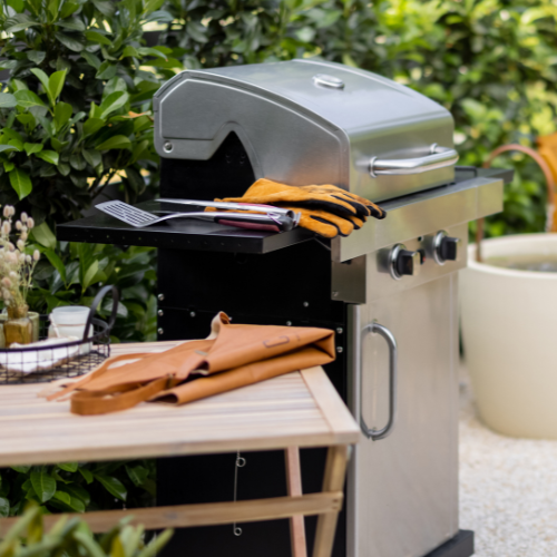 A propane grill setup outdoors on a clear day.